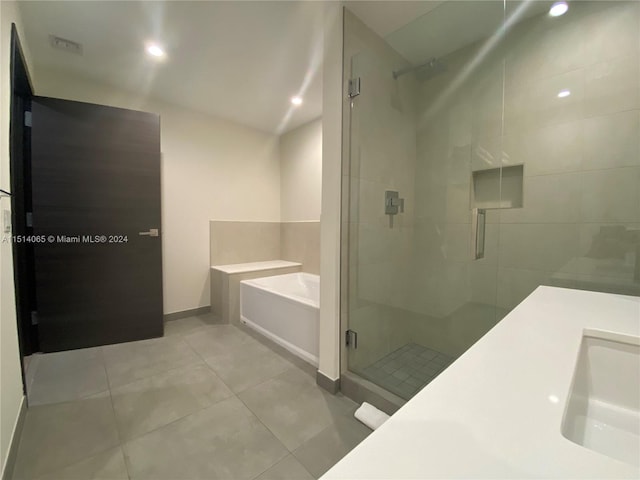 bathroom featuring independent shower and bath and tile floors