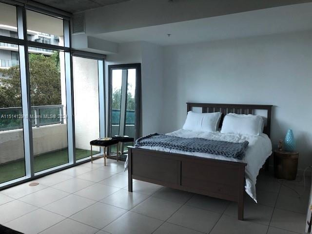 tiled bedroom featuring expansive windows