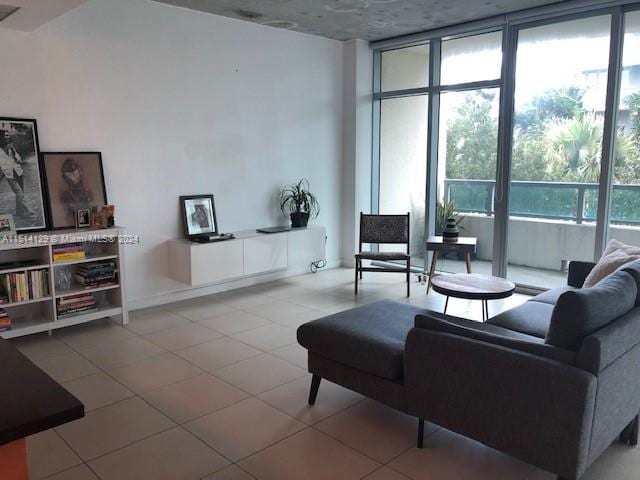 living room with tile patterned flooring, a healthy amount of sunlight, and expansive windows