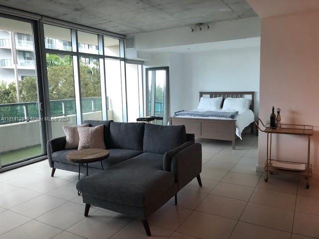 bedroom with light tile patterned flooring and expansive windows