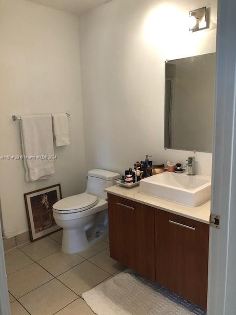 bathroom with tile patterned flooring, toilet, and vanity