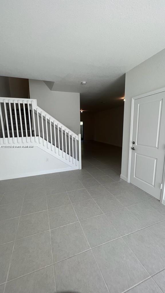 corridor with light tile floors