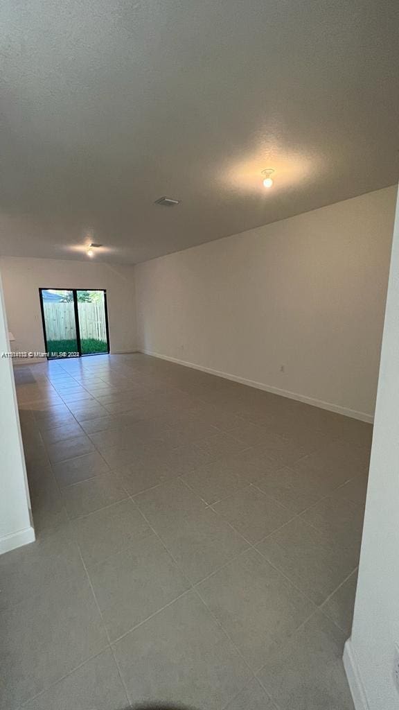 unfurnished room featuring tile flooring