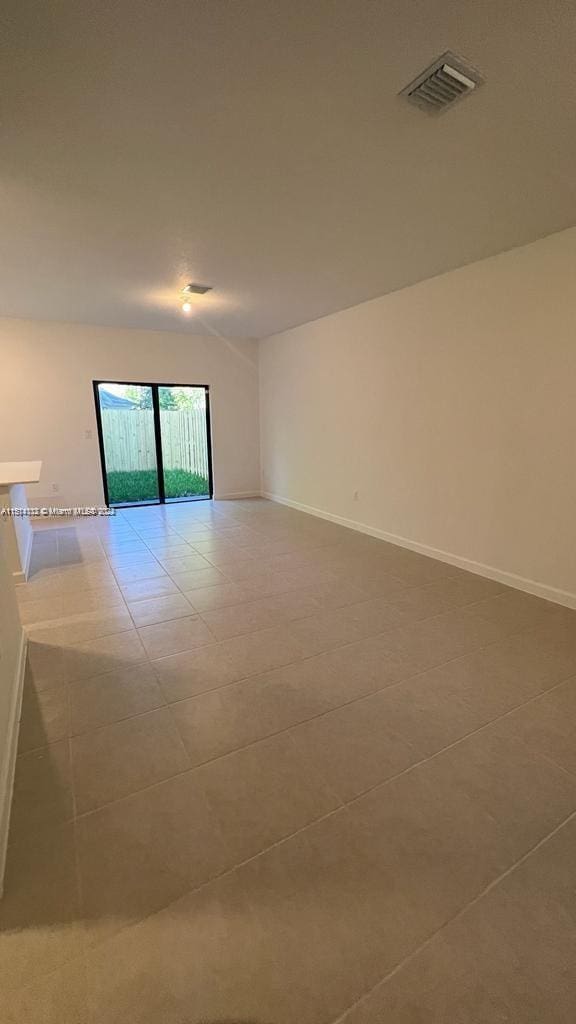 empty room with light tile floors