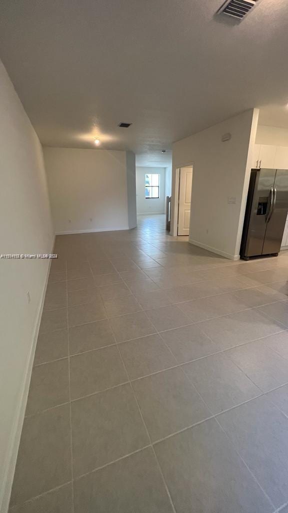 unfurnished room with light tile flooring