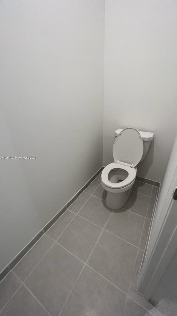 bathroom with toilet and tile flooring