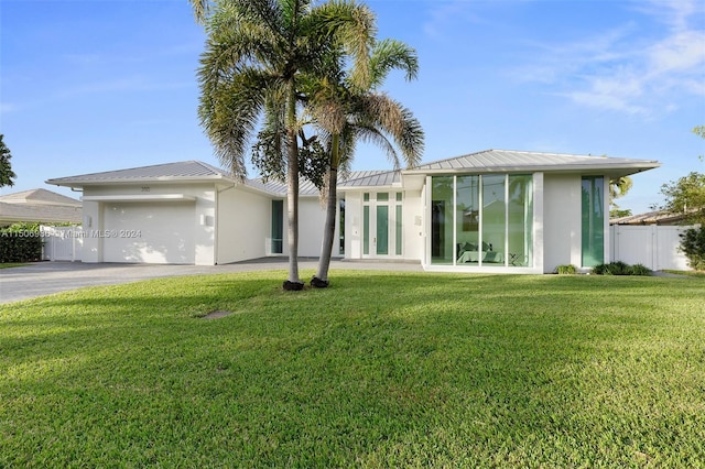 view of front of property with a garage and a front yard