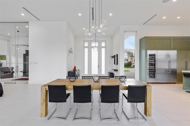 kitchen featuring built in fridge, plenty of natural light, hanging light fixtures, and light tile patterned floors