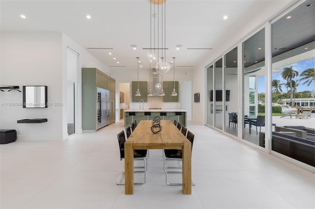 dining space with sink and light tile patterned flooring