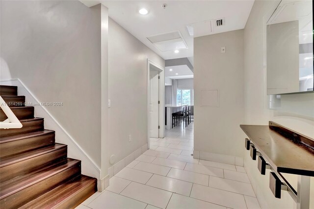 hall with light tile patterned floors