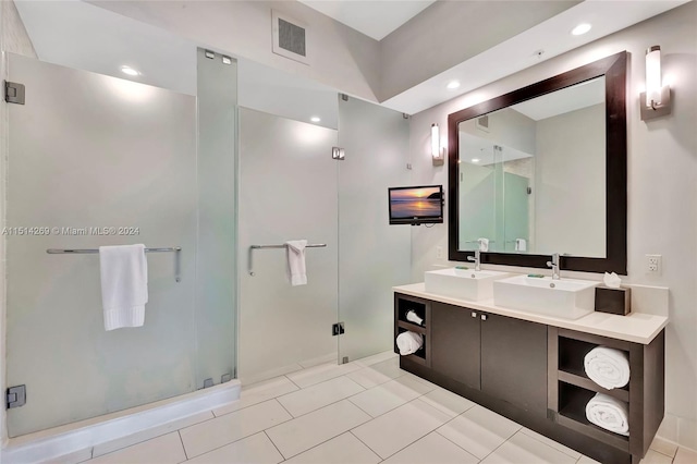 bathroom with vanity, a shower with shower door, and tile patterned flooring