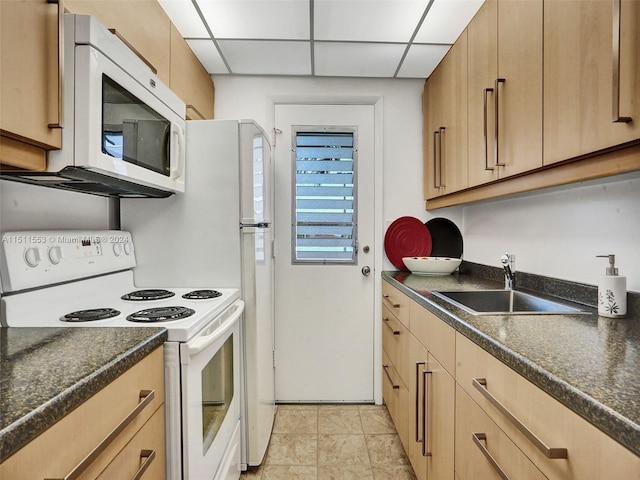 kitchen with a paneled ceiling, sink, light brown cabinetry, and white appliances