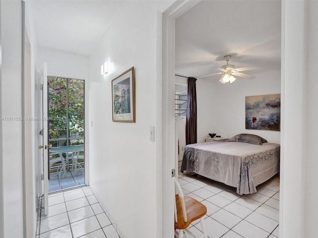 bedroom featuring access to exterior, ceiling fan, and light tile patterned floors