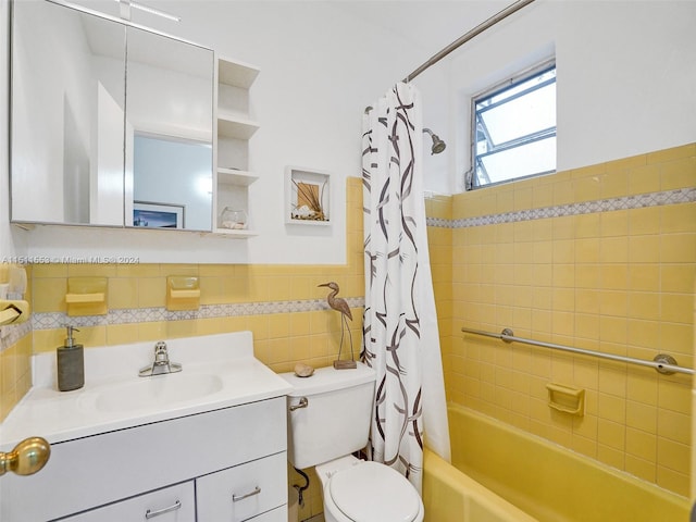 full bathroom featuring shower / bath combo, toilet, tile walls, and vanity