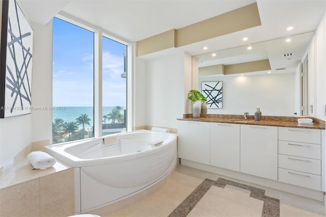 bathroom with vanity, a water view, plenty of natural light, and tile patterned flooring