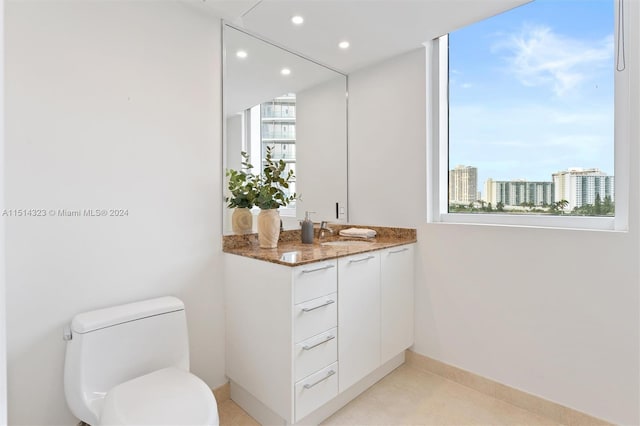 bathroom with tile patterned floors, vanity, and toilet