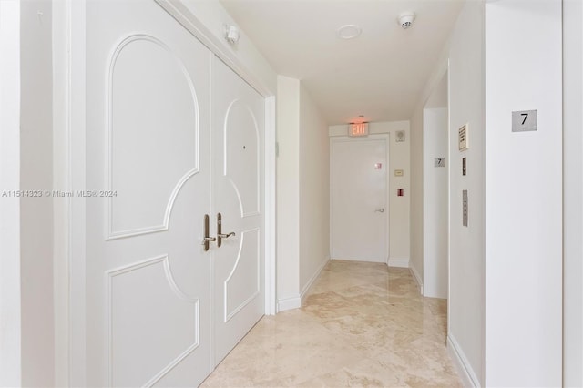 hall with light tile patterned flooring