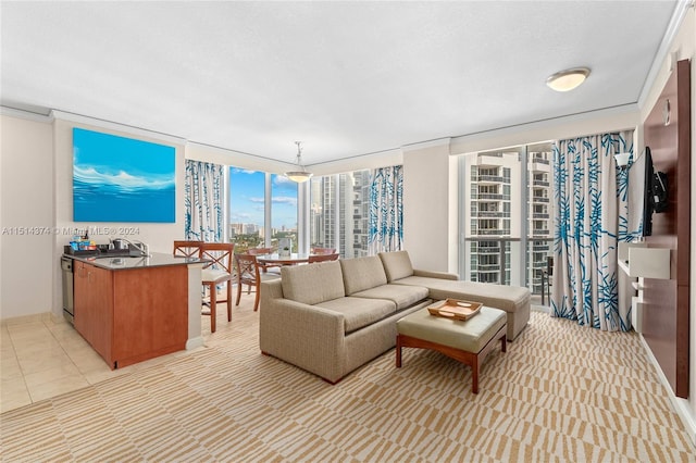 living room featuring floor to ceiling windows, light tile patterned flooring, and sink