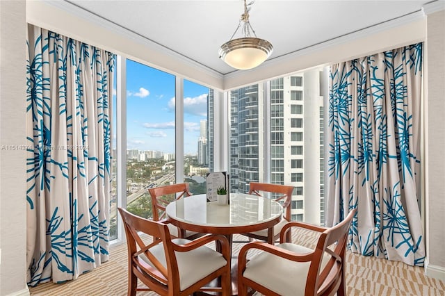 dining space with crown molding