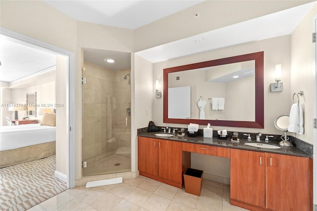 bathroom featuring tile patterned floors, vanity, and a shower with shower door