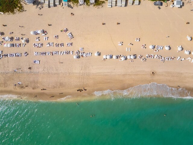 drone / aerial view featuring a water view and a beach view