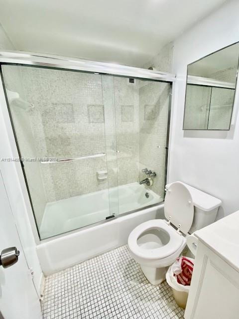 full bathroom with toilet, shower / bath combination with glass door, tile patterned flooring, and vanity