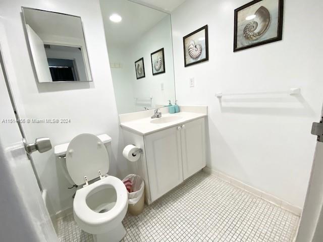 bathroom with tile patterned flooring, toilet, and vanity