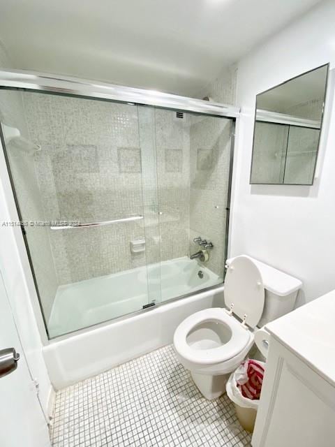 full bathroom with vanity, toilet, tile patterned flooring, and enclosed tub / shower combo