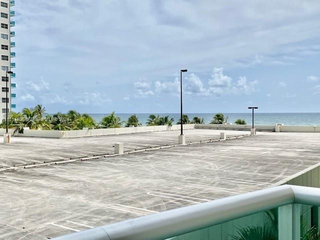 view of car parking with a water view