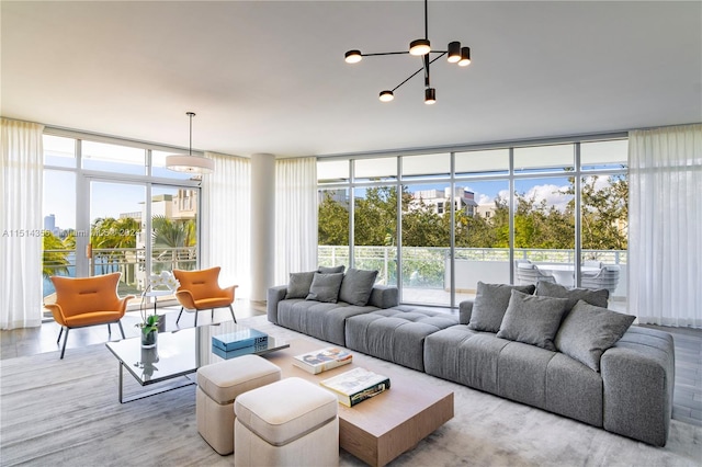 living room featuring light hardwood / wood-style floors, expansive windows, and a healthy amount of sunlight