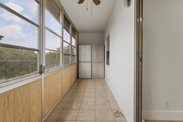 unfurnished sunroom featuring ceiling fan