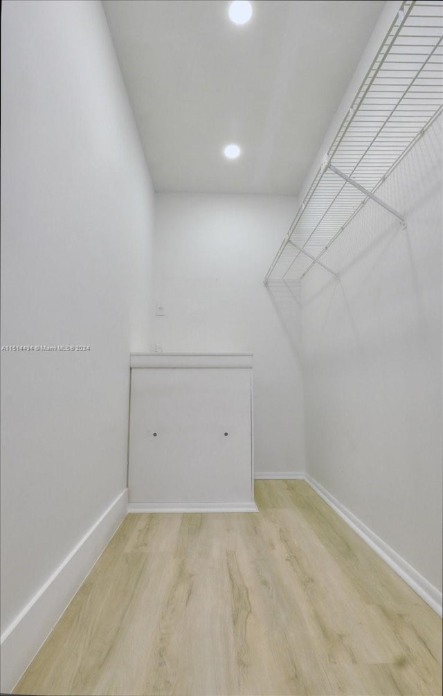 spacious closet with light hardwood / wood-style flooring