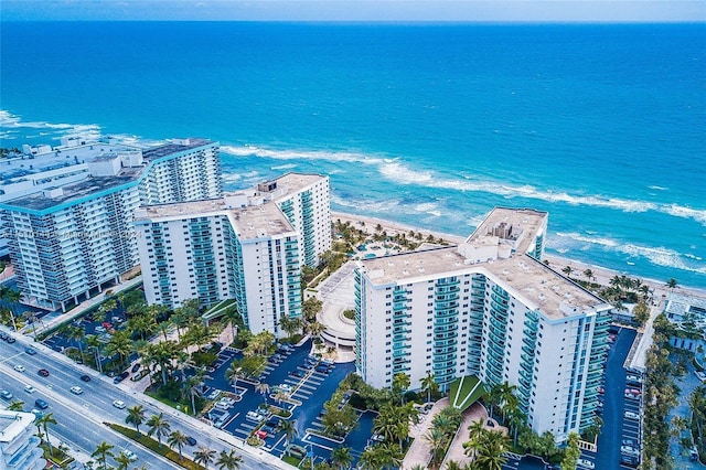 drone / aerial view with a water view and a beach view