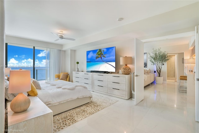 bedroom featuring a water view, access to exterior, ceiling fan, and light tile floors