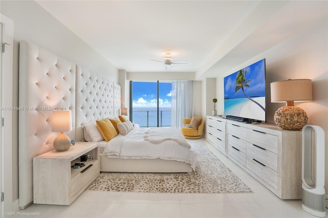 tiled bedroom featuring a water view, ceiling fan, and access to outside