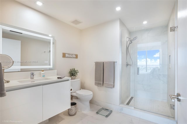 bathroom featuring oversized vanity, tile floors, a shower with shower door, and toilet