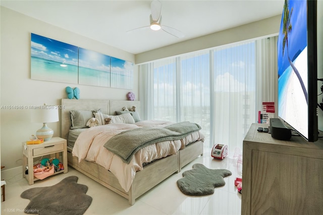 tiled bedroom featuring ceiling fan