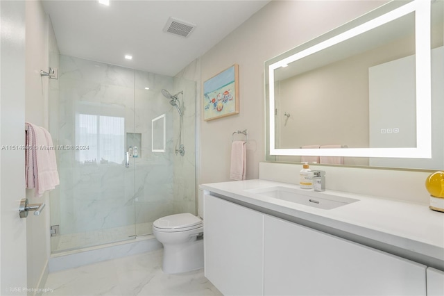 bathroom featuring vanity, tile flooring, a shower with shower door, and toilet