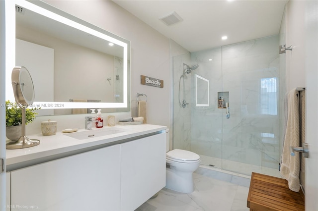 bathroom with toilet, vanity, a shower with shower door, and tile flooring