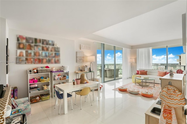 playroom with light tile flooring and expansive windows