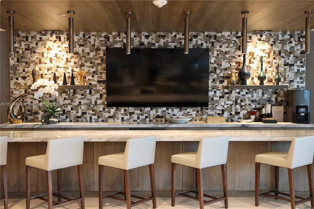 bar with wood ceiling, backsplash, and light stone counters