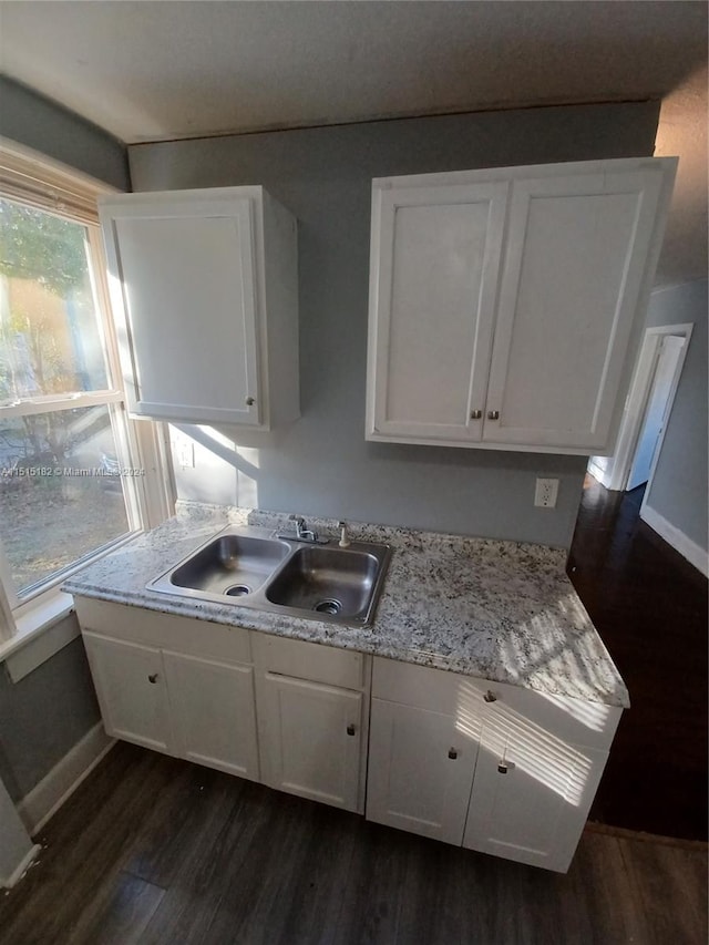 kitchen with white cabinets, sink, and dark wood-type flooring