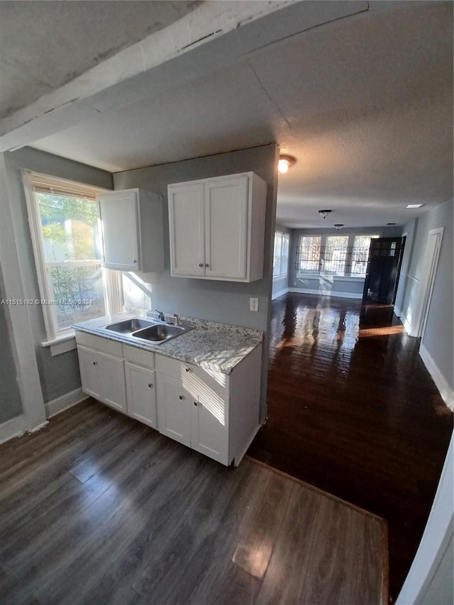 kitchen with white cabinets, dark hardwood / wood-style flooring, and sink