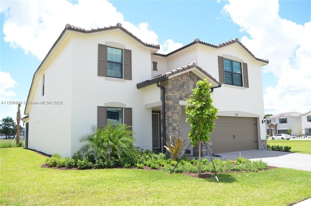 mediterranean / spanish house featuring a front lawn and a garage