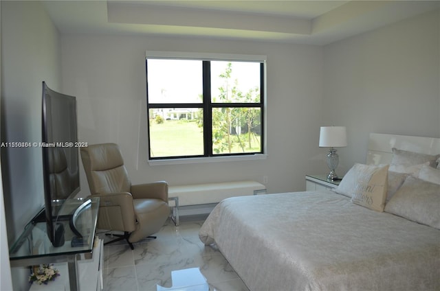 tiled bedroom featuring a raised ceiling