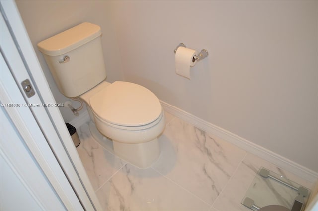 bathroom with toilet and tile floors