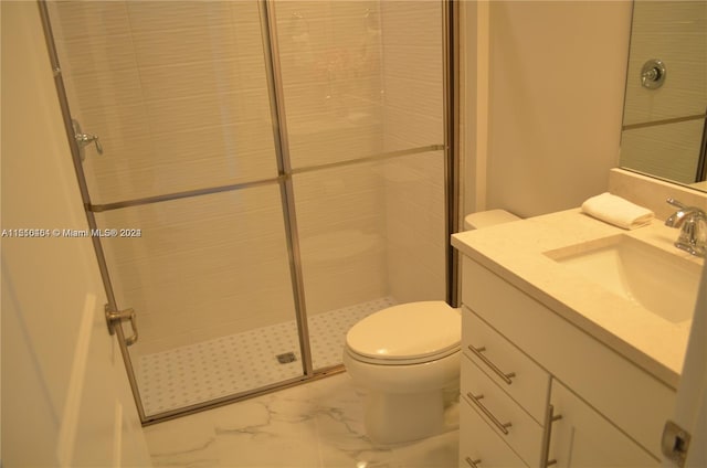 bathroom with tile floors, toilet, vanity, and a shower with shower door