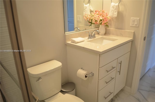 bathroom featuring vanity, tile flooring, and toilet