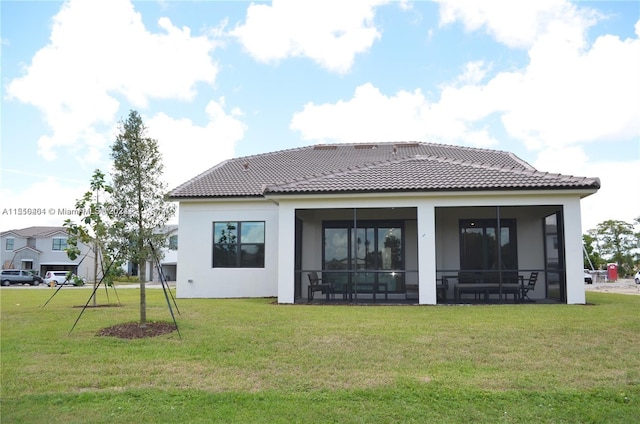 back of house with a lawn