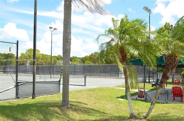 view of sport court with a yard